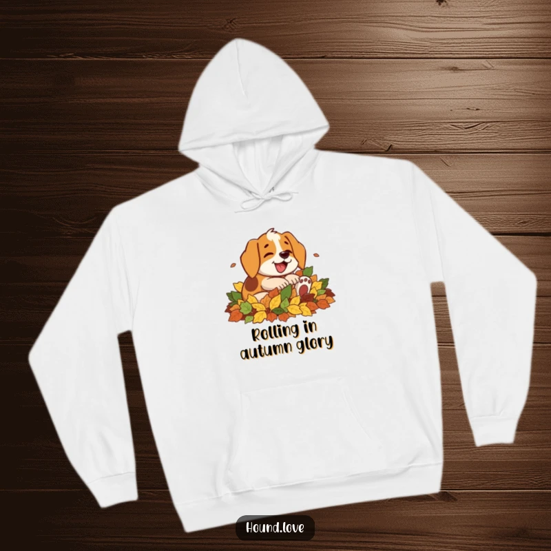 Funny hoodie print of a happy hound character with a joyful bark, enthusiastically rolling over in a large pile of colorful autumn leaves.