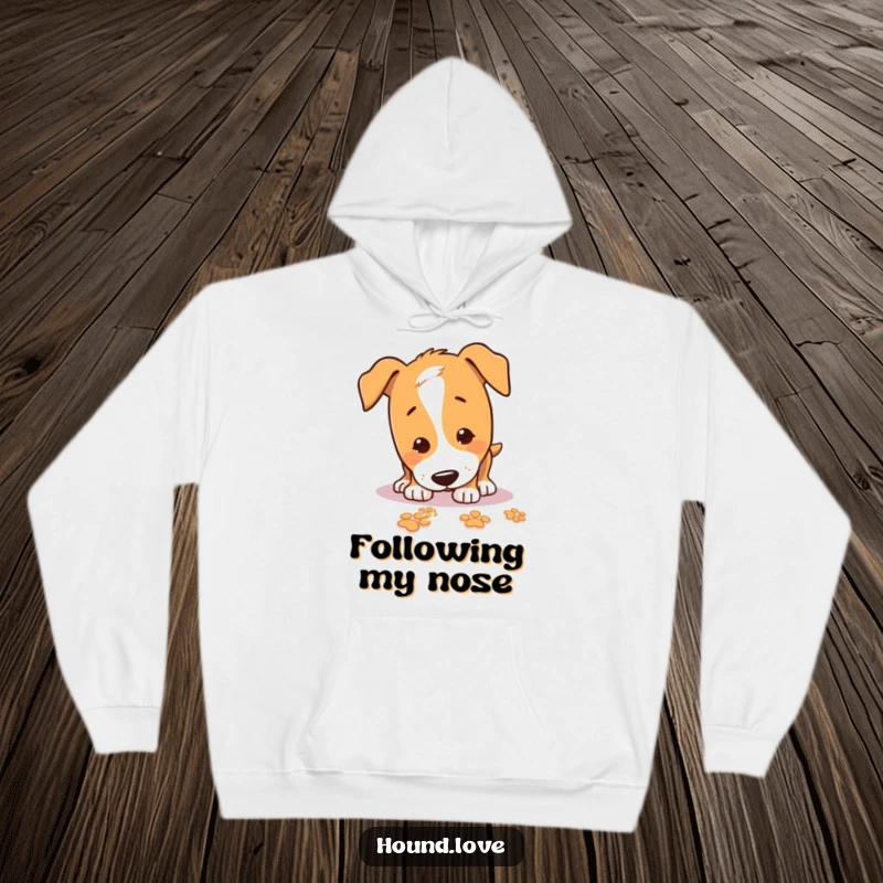 Funny Hoodie with a playful hound intently sniffing the ground, following a sparkling trail of paw prints with glee.