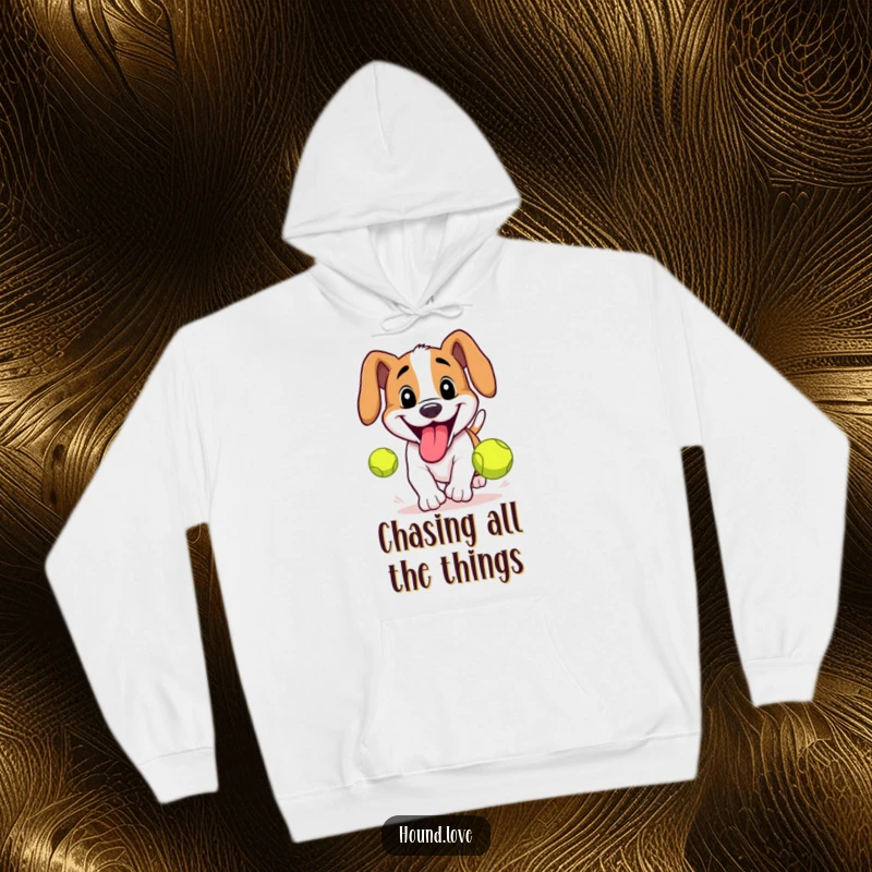 Funny Hound Hoodie: Hound with a big grin and lolling tongue chasing a tennis ball, offering cozy and humorous vibes.