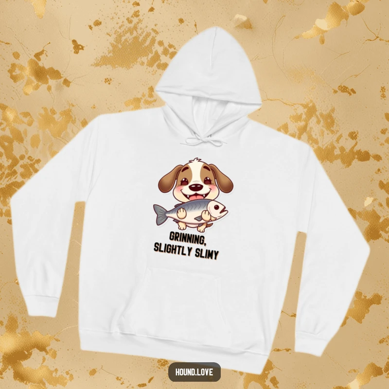 Funny hound with a wide, goofy grin, holding a slippery fish, on a cozy hoodie, perfect for humor and warmth.