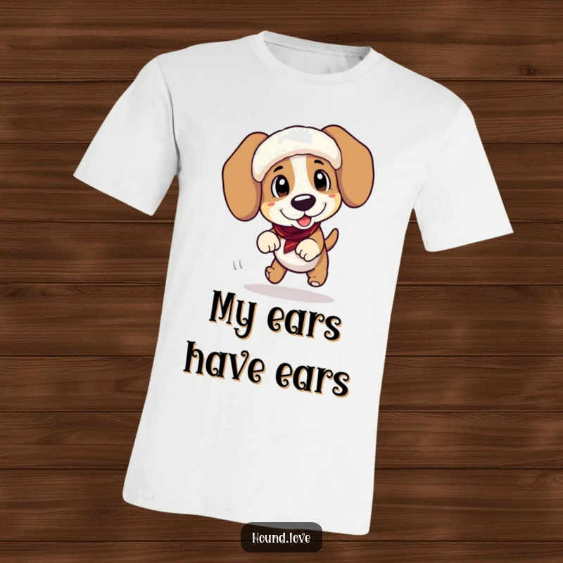 Funny t-shirt of a goofy hound tripping comically while wearing enormous, floppy ear muffs, perfect for pet humor.
